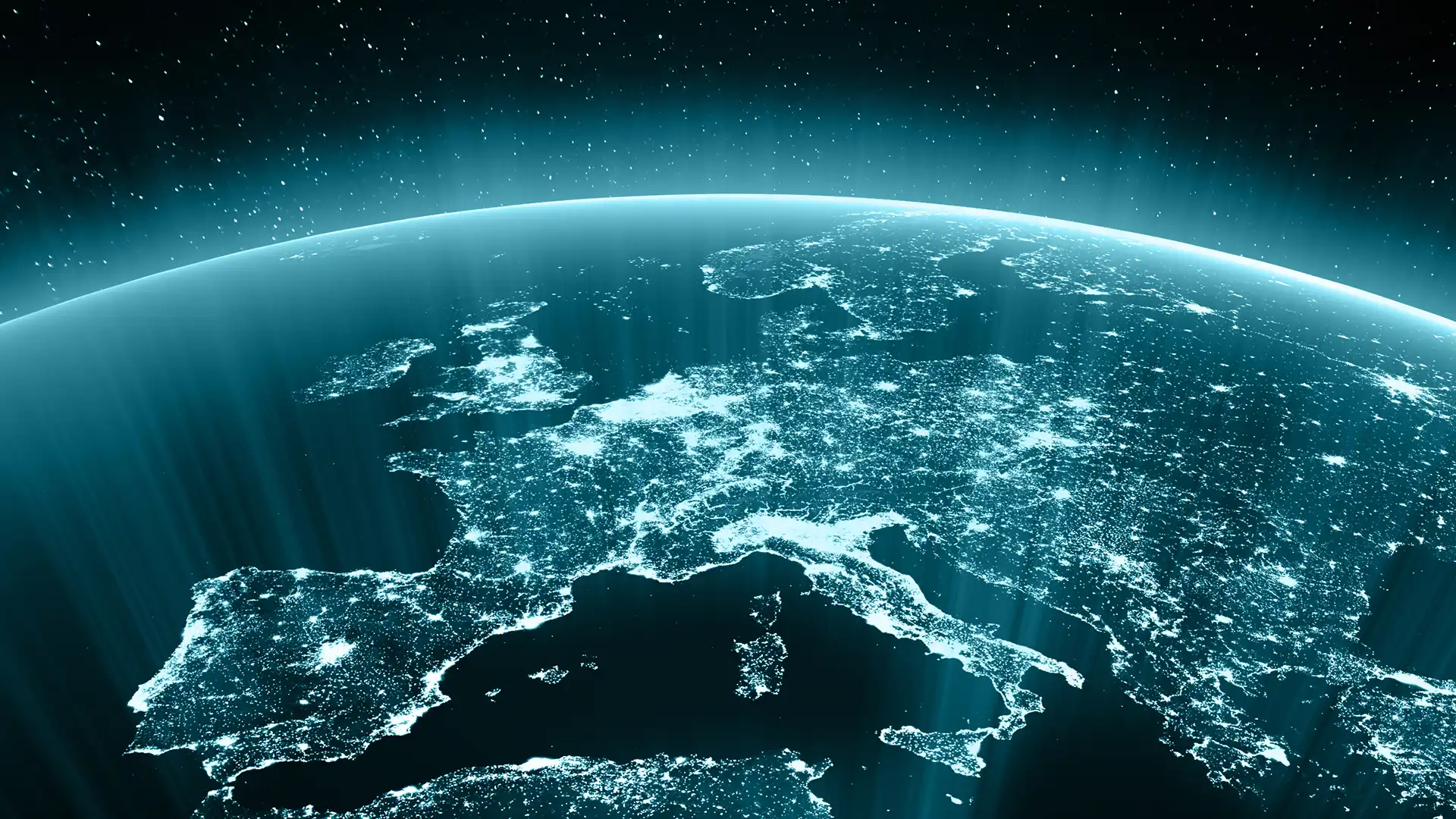 View of Europe from space at night, with glowing city lights, atmospheric blue haze and stars illuminating the continent below vividly.